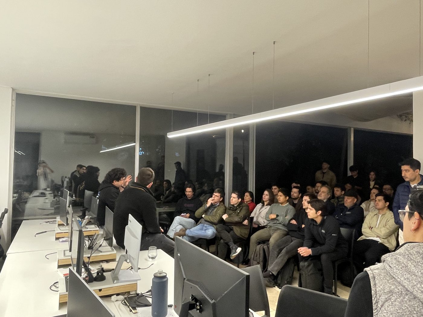 A packed room listening at a Growth Conversations meetup